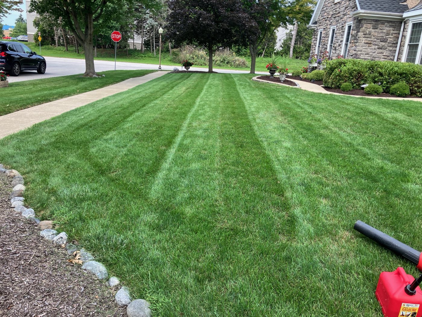 Clean mowing stripes leading to a landscaped front bed